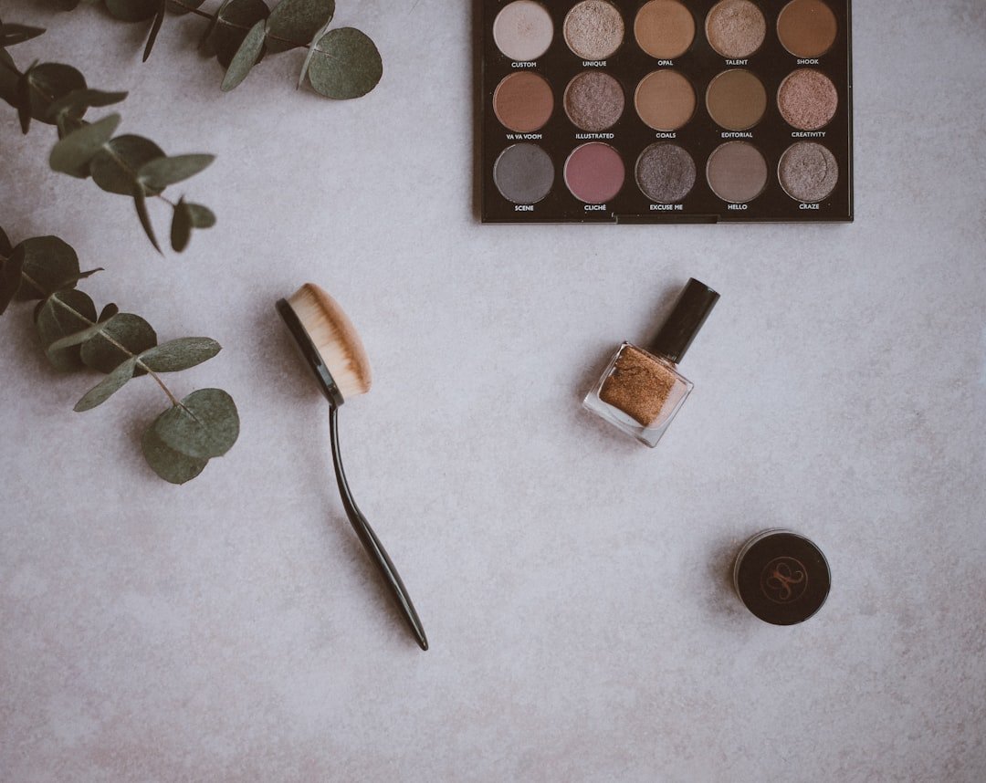 A simple makeup setup with essential products like foundation, mascara, and lip balm on a clean vanity.
