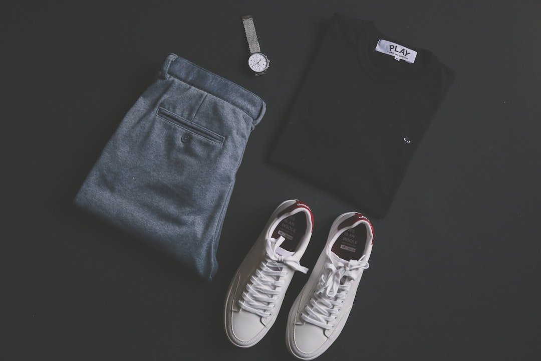 A stylish person wearing a smart-casual outfit, showcasing clean lines and intentional accessories in a relaxed setting.