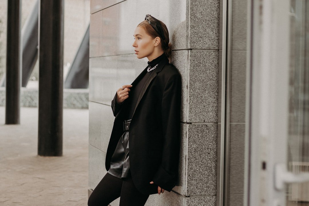 A stylish person wearing a blazer over a casual outfit, showcasing versatility in fashion.